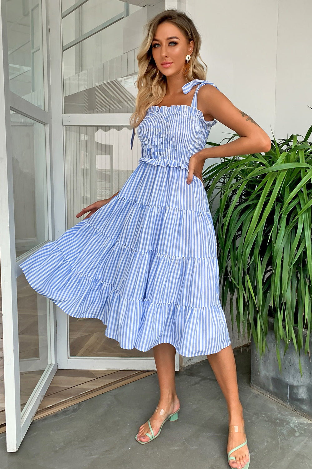 Blue striped tiered midi dress with smocked bodice and tie straps