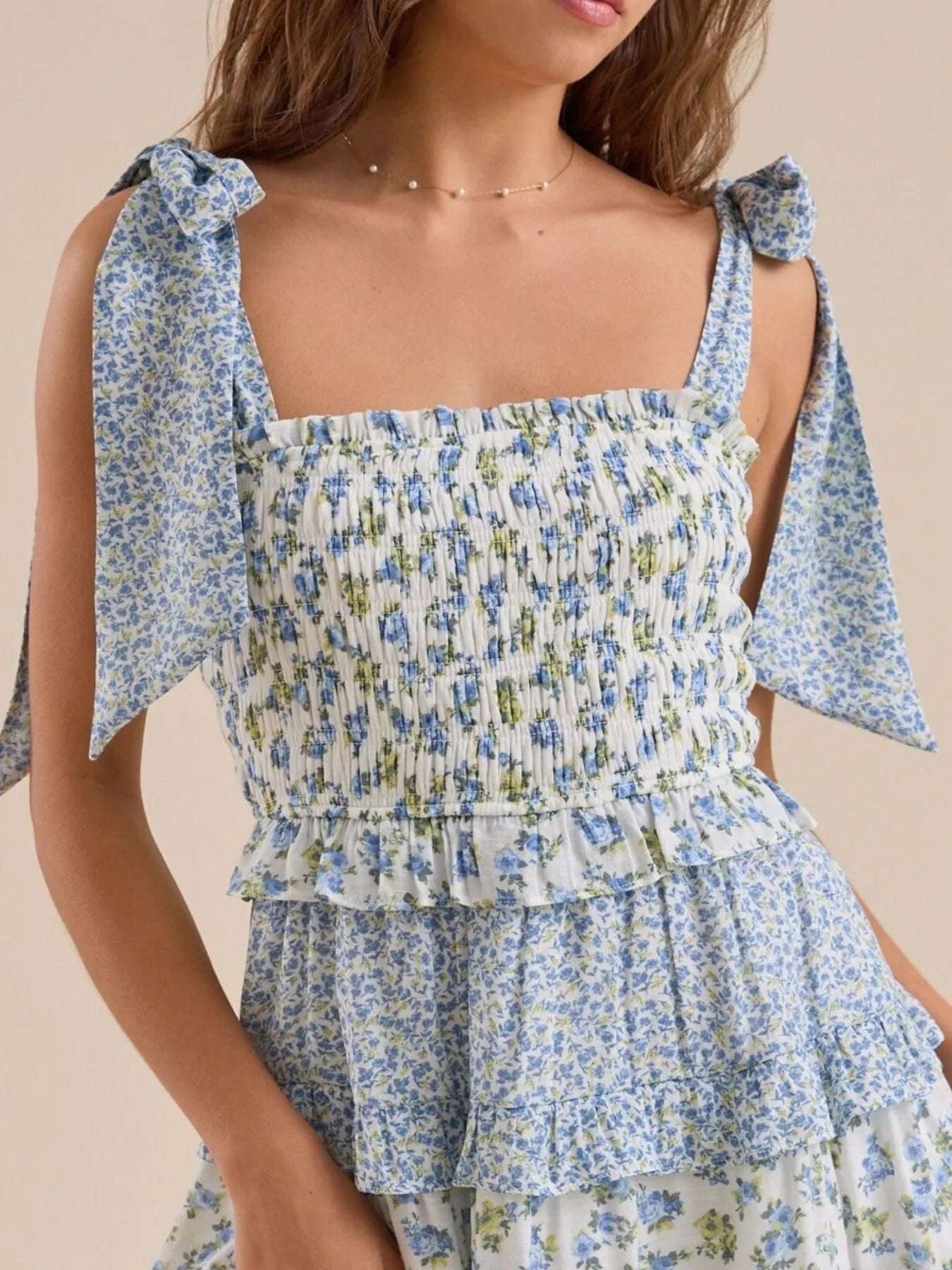 Blue floral tiered mini dress with adjustable tie shoulder straps