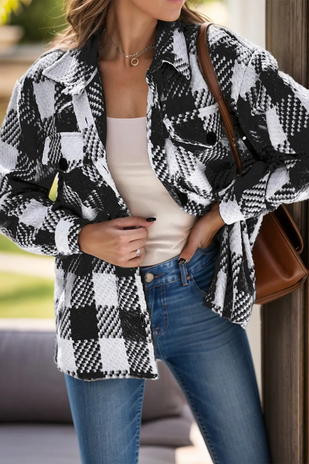 Black and white plaid button-down jacket styled with denim jeans