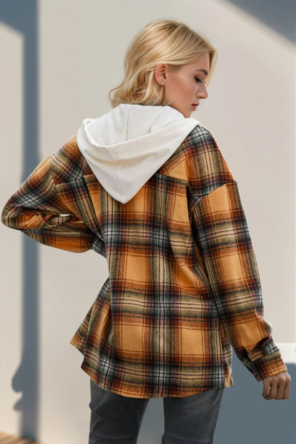 Back view of plaid hooded shacket layered over casual outfit