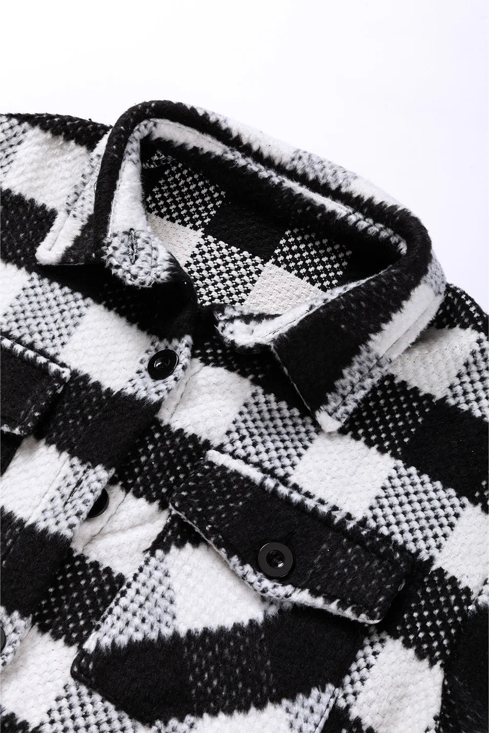 Close-up of plaid jacket collar in black and white check