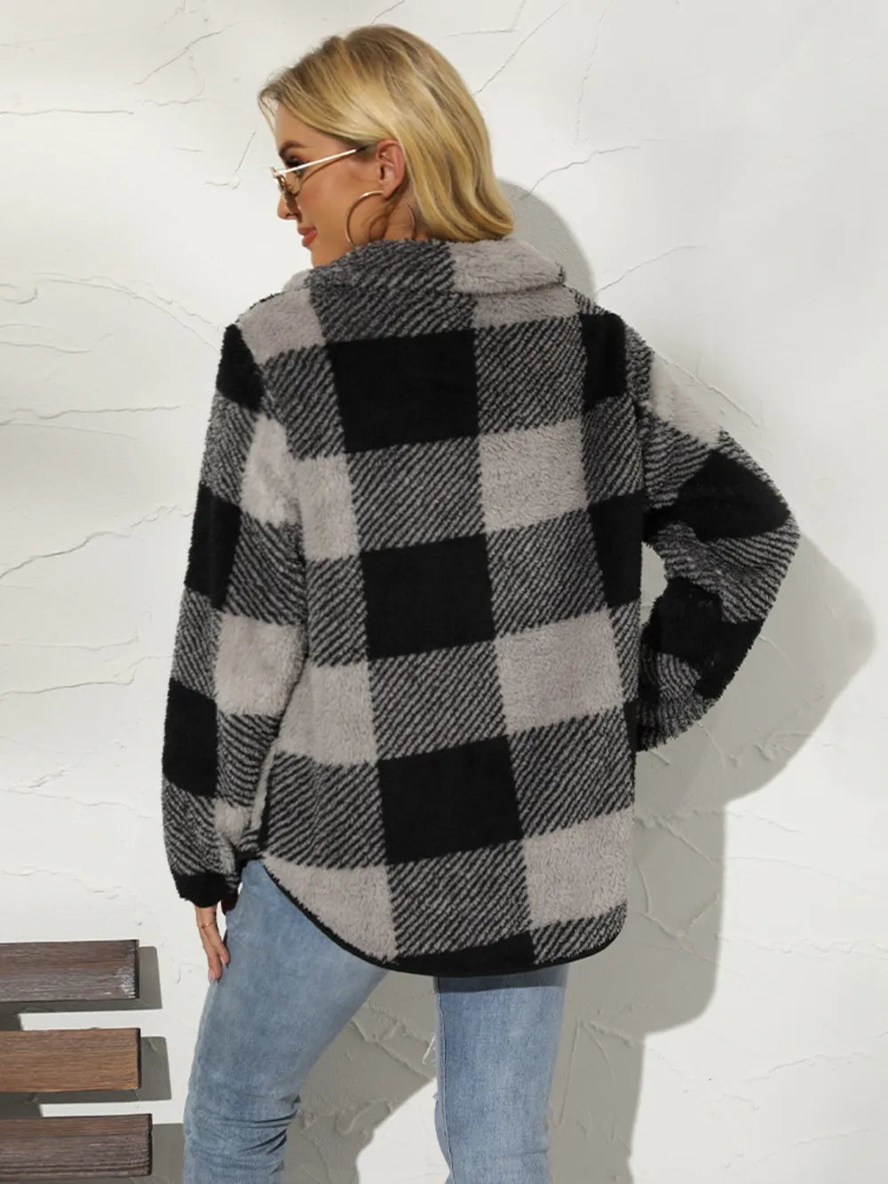 Back view of black plaid half-zip pullover with long sleeves