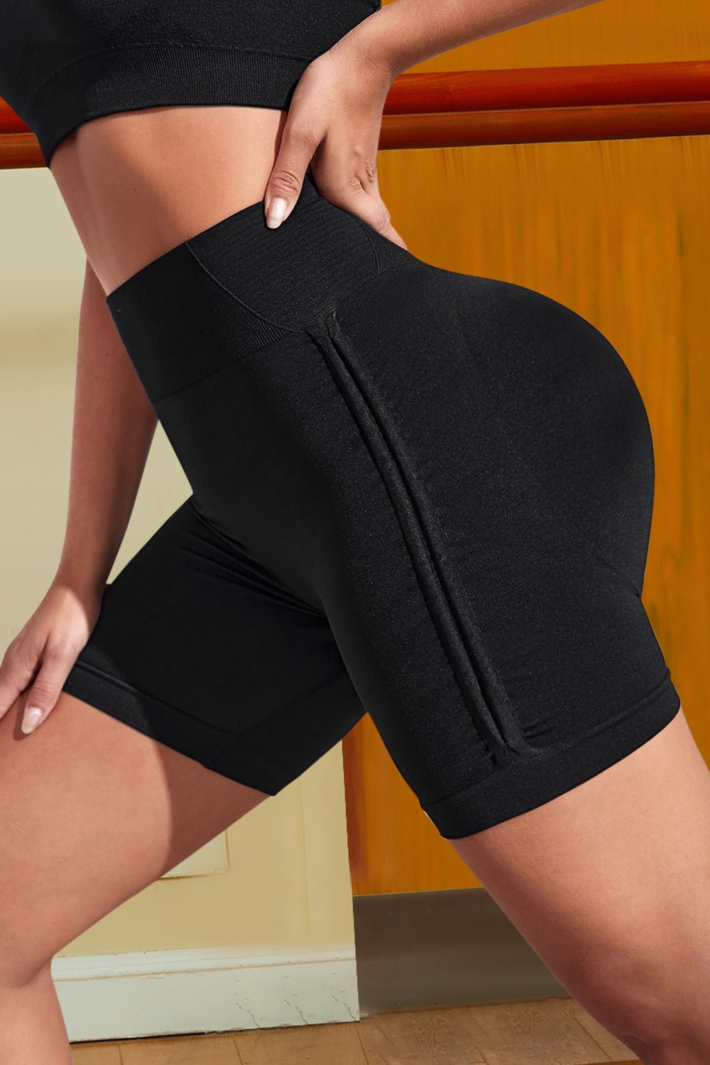 Side angle of black workout shorts with breathable quick-dry fabric
