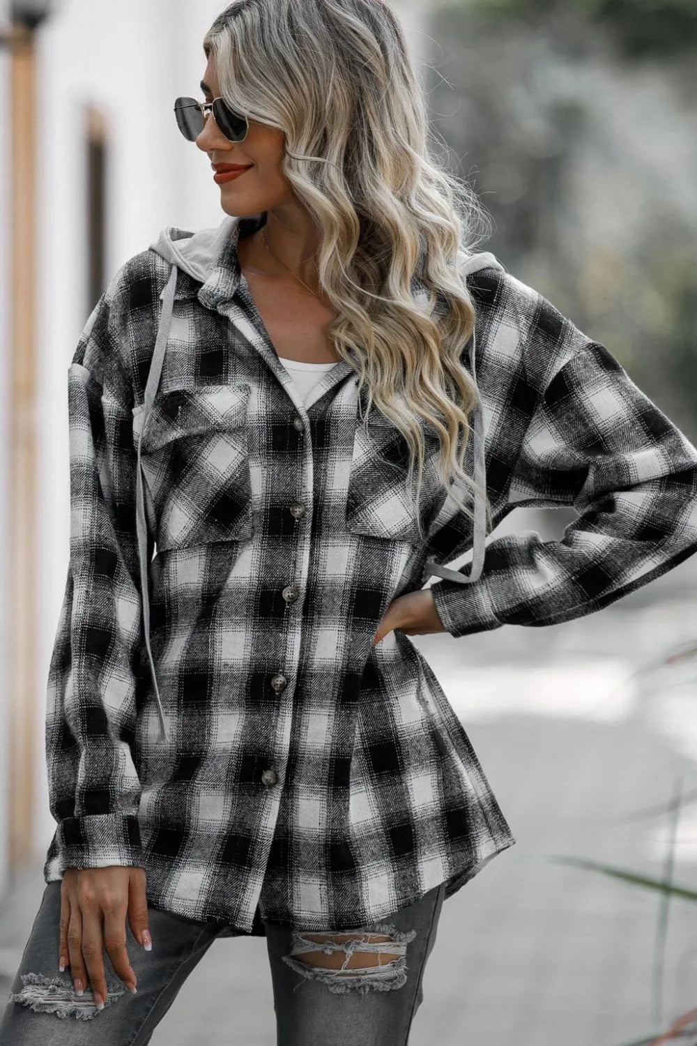 Front view of black plaid shacket with hood and side pockets