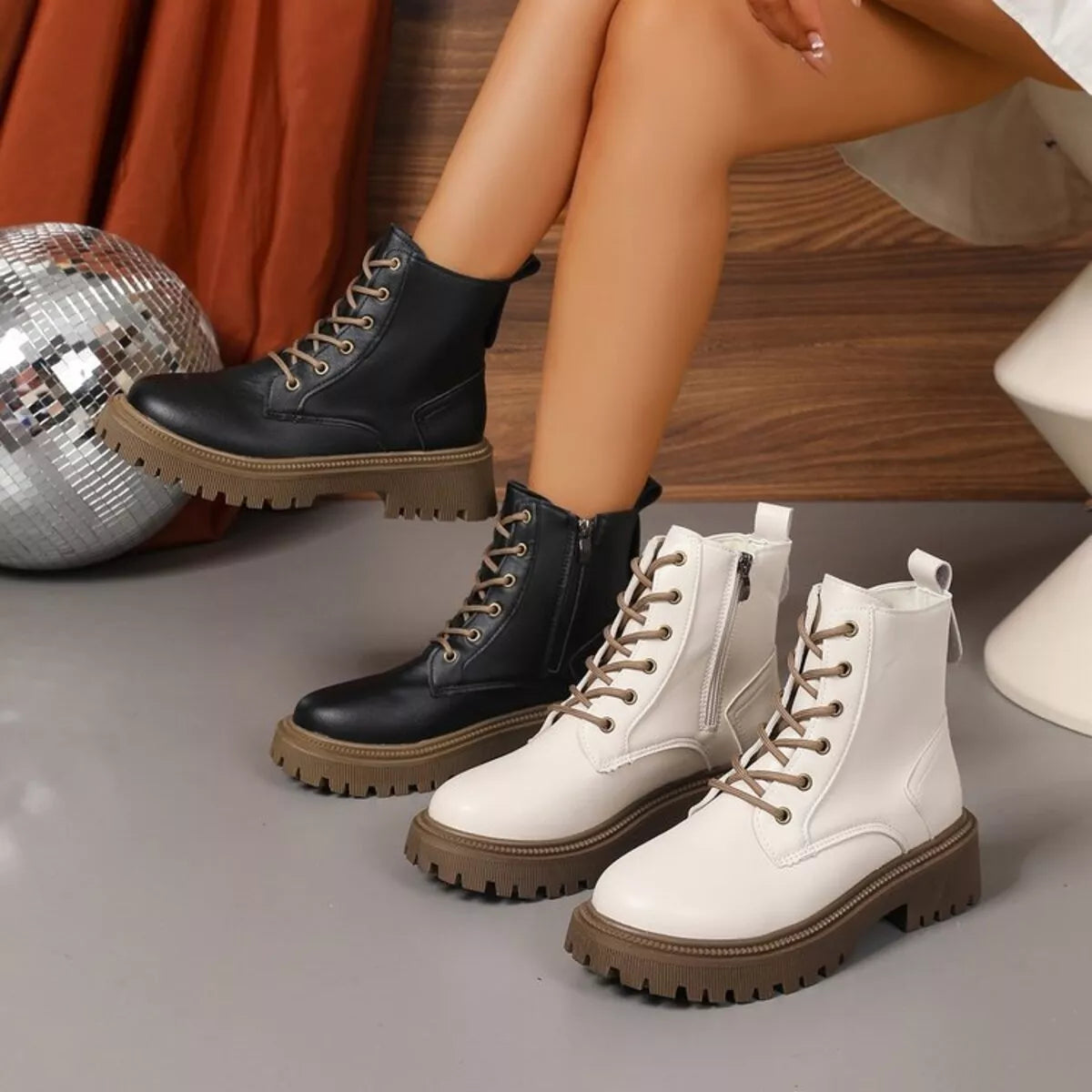 Black lace up round toe boots with mid-heels styled with dress