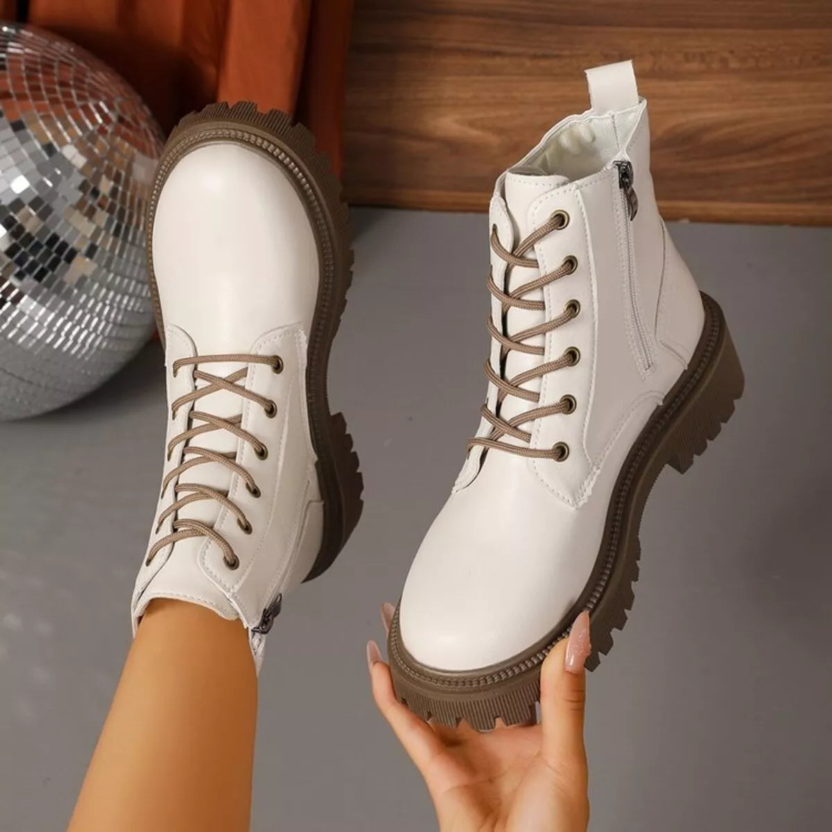 Close-up of lace up round toe boot details and stitching