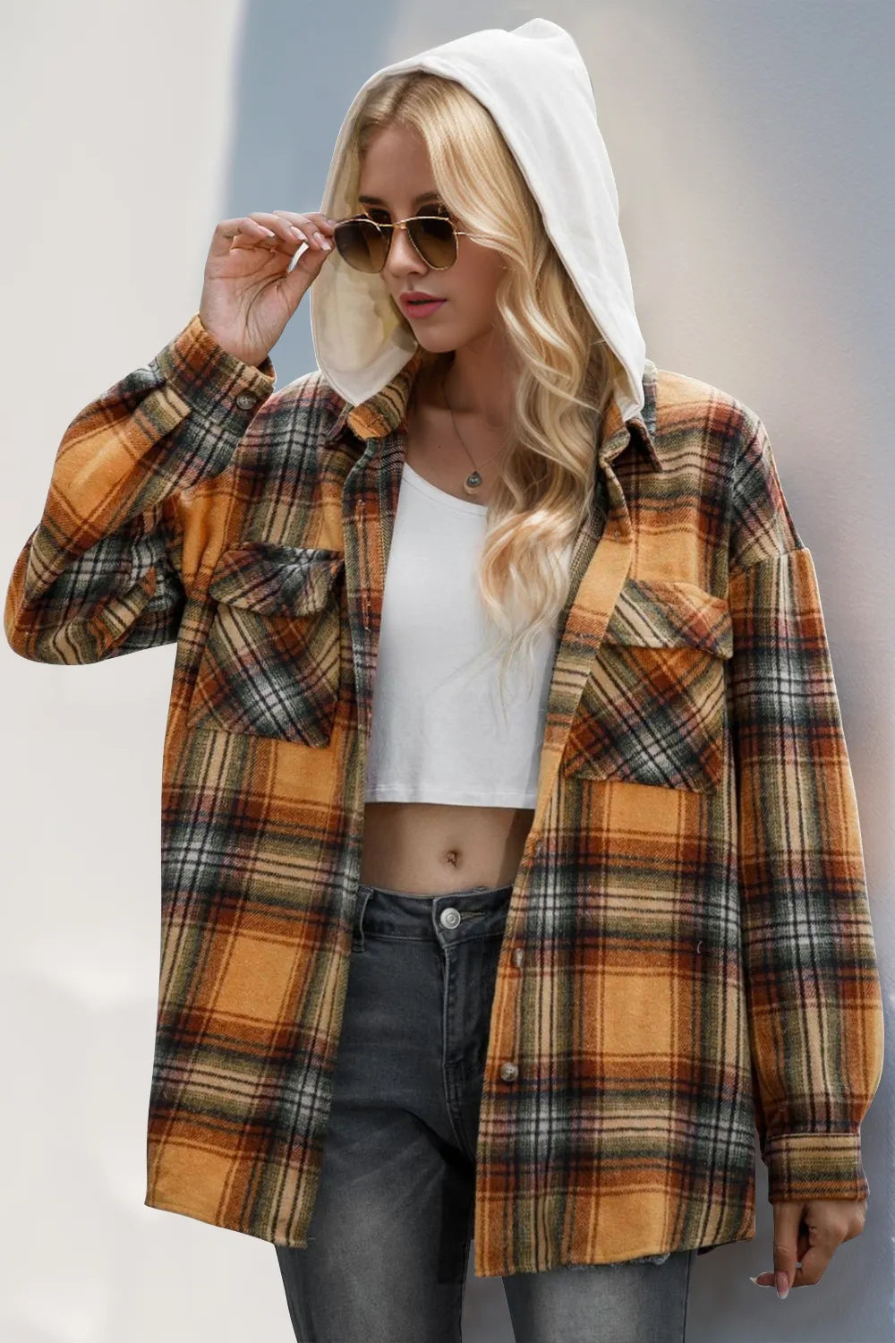 Brown plaid hooded shacket with button-down closure styled casually