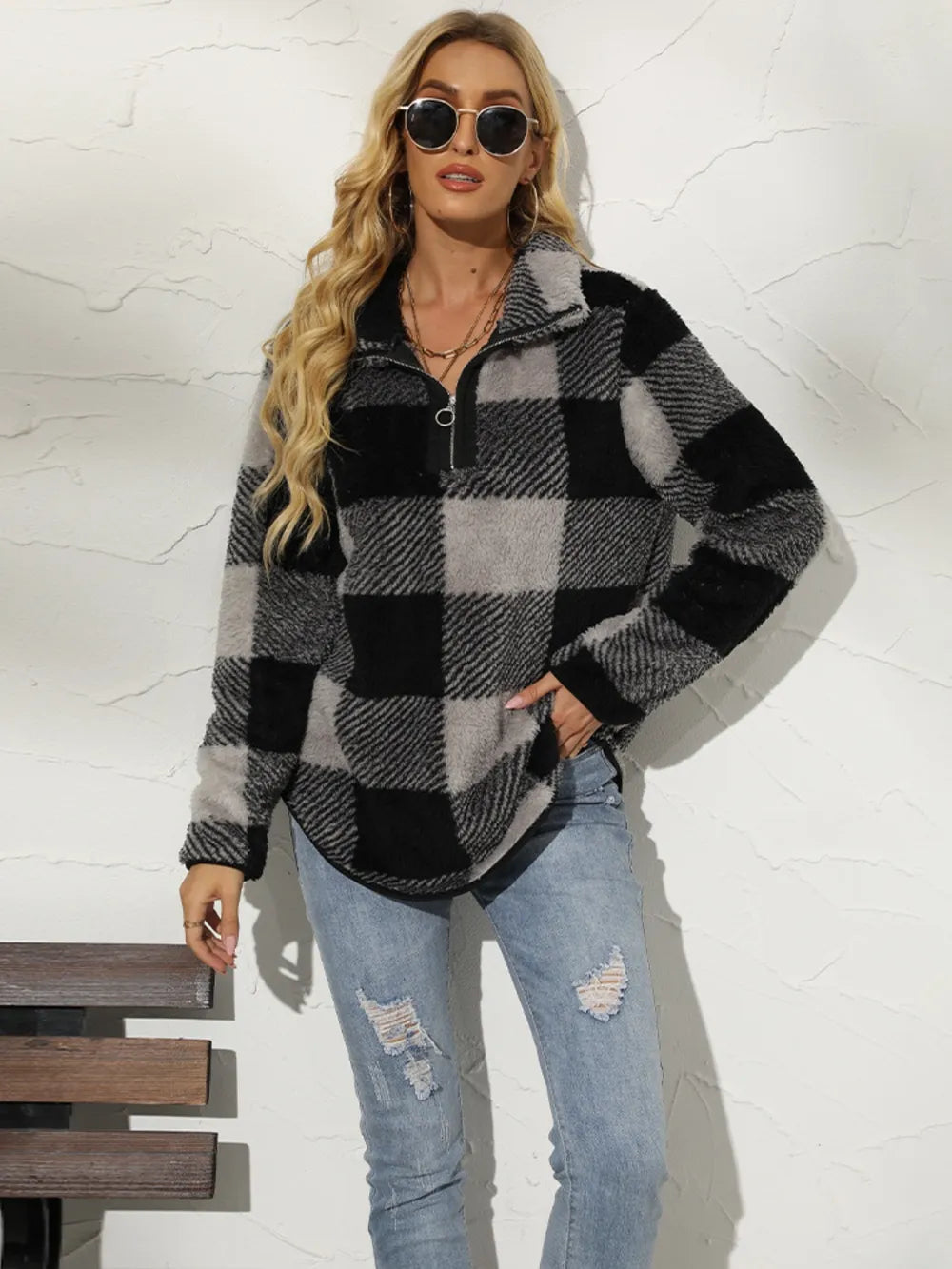 Side angle of black plaid fleece sweatshirt with zipper front