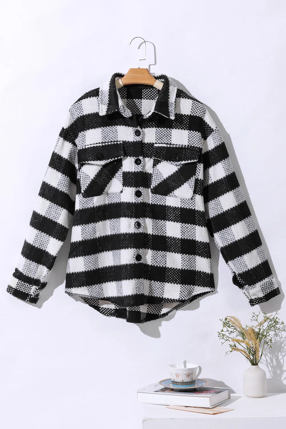 Flat lay of plaid jacket with button-down front and pocket details