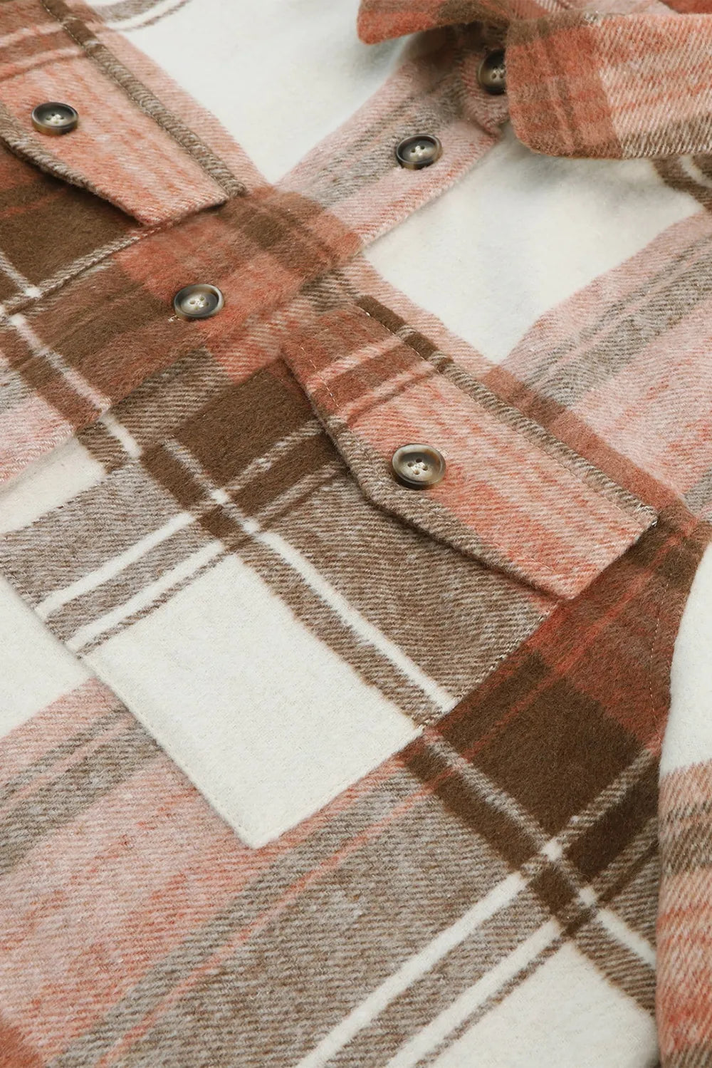 Detail view of shacket chest pockets with plaid design