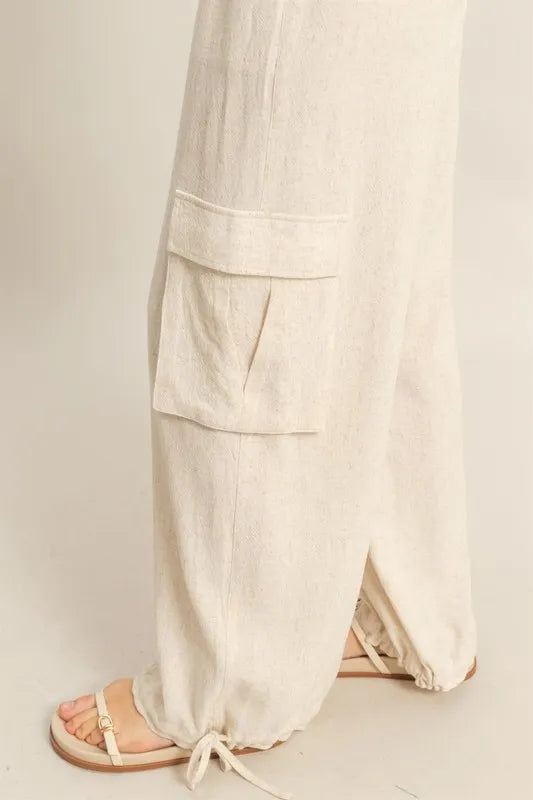 Close-up of wide-leg cream pants with drawstring waist detail