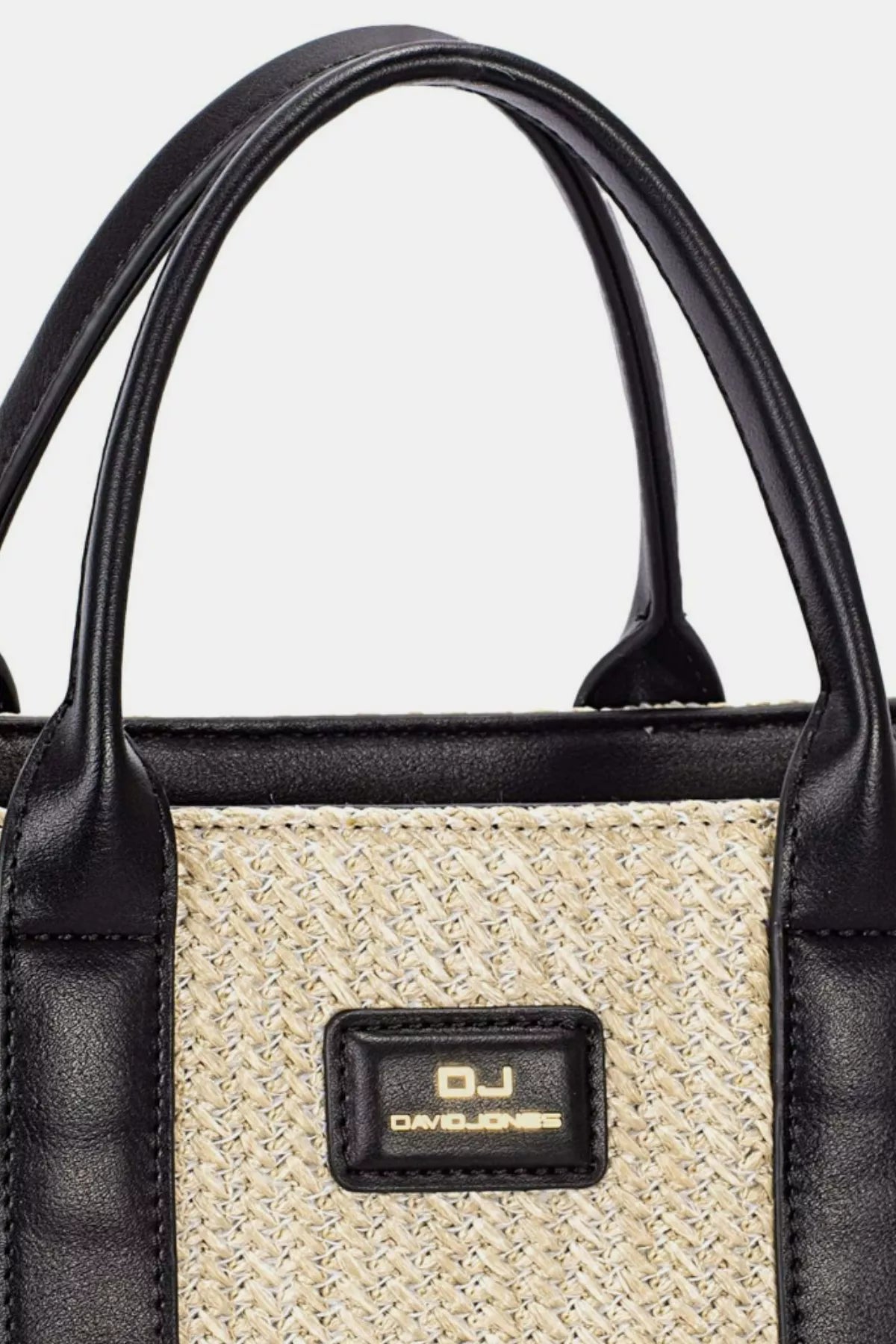 Close up view of David Jones woven tote handbag with square silhouette